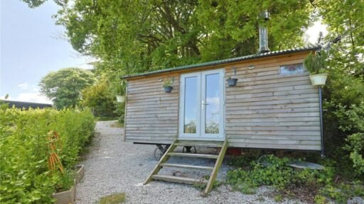 Charming £100,000 wooden shepherd’s hut near Penryn offers meadowland, pond, log fire and stunning countryside views, ideal as a retreat, glamping or holiday let.