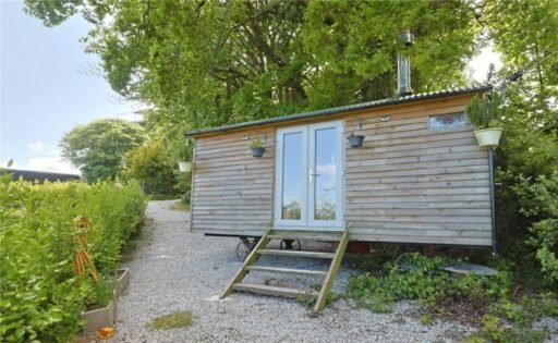 Charming £100,000 wooden shepherd’s hut near Penryn offers meadowland, pond, log fire and stunning countryside views, ideal as a retreat, glamping or holiday let.