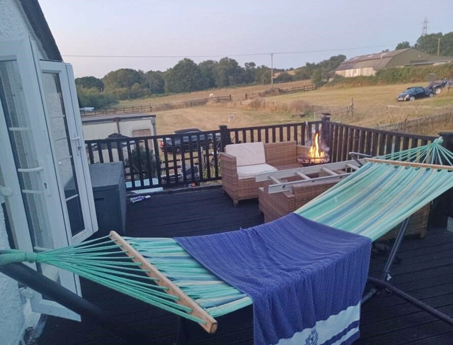 Charming 17th century Dorset cottage for £785,000 with four bedrooms, hot tub, Tiki bar and grazing land - but quirky photos reveal bare feet on show in the listing.