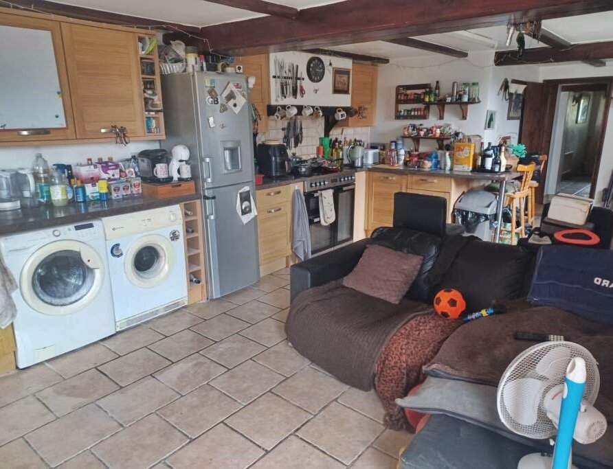 Charming 17th century Dorset cottage for £785,000 with four bedrooms, hot tub, Tiki bar and grazing land - but quirky photos reveal bare feet on show in the listing.