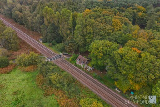 A £300,000 two-bedroom cottage in Norfolk offers rustic charm and woodland seclusion just feet from train tracks, blending period character with unique rural living.