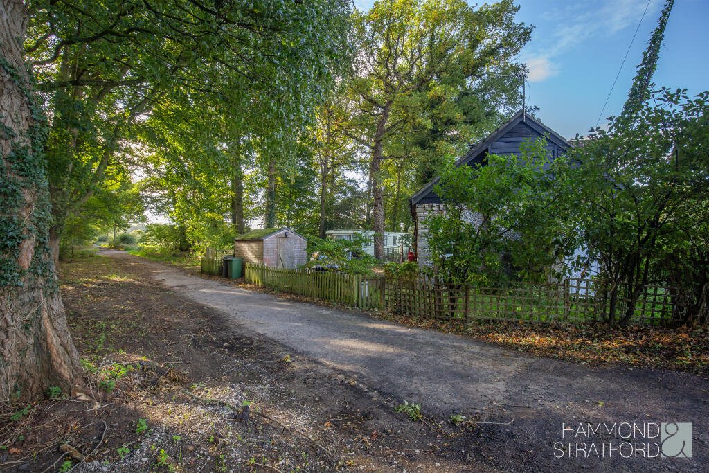 A £300,000 two-bedroom cottage in Norfolk offers rustic charm and woodland seclusion just feet from train tracks, blending period character with unique rural living.