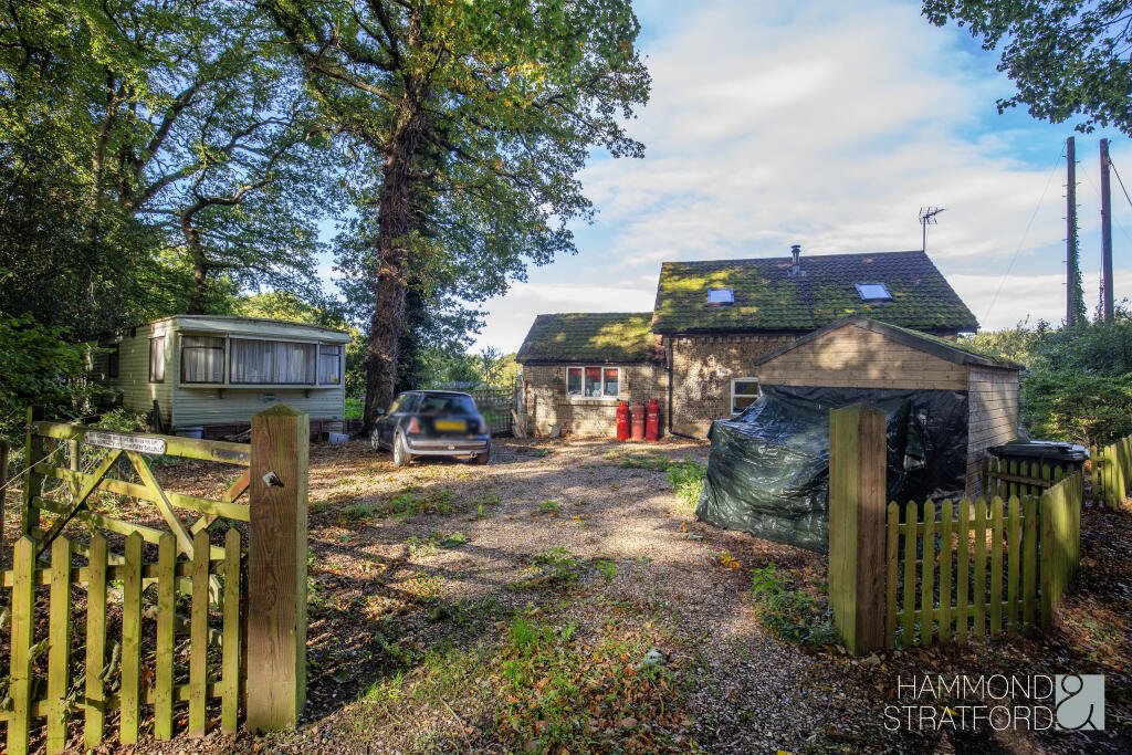 A £300,000 two-bedroom cottage in Norfolk offers rustic charm and woodland seclusion just feet from train tracks, blending period character with unique rural living.