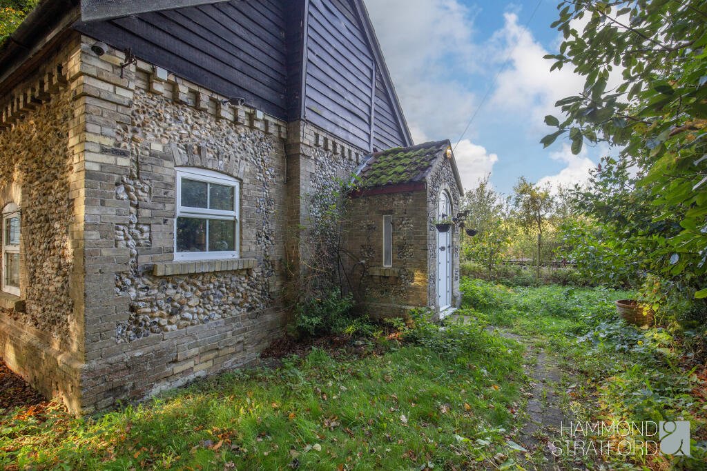 A £300,000 two-bedroom cottage in Norfolk offers rustic charm and woodland seclusion just feet from train tracks, blending period character with unique rural living.