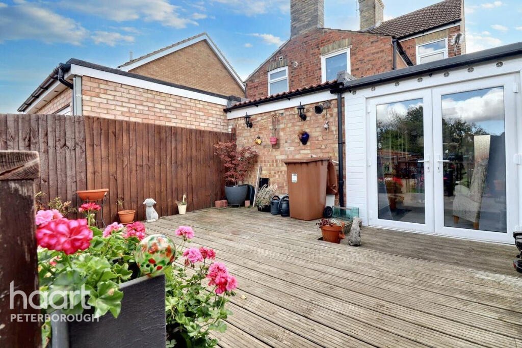 Unassuming three-bed home in Peterborough listed at £240,000 hides a striking Coca Cola themed lounge with bold red walls, memorabilia, and unique retro inspired decor.