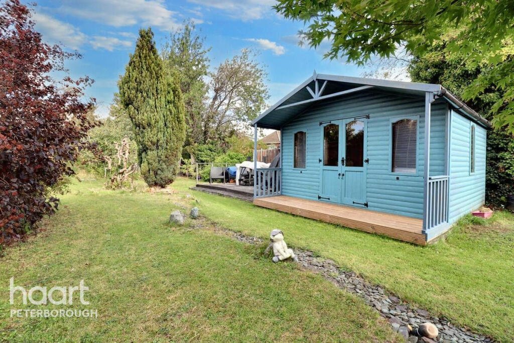 Unassuming three-bed home in Peterborough listed at £240,000 hides a striking Coca Cola themed lounge with bold red walls, memorabilia, and unique retro inspired decor.