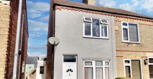 Unassuming three-bed home in Peterborough listed at £240,000 hides a striking Coca Cola themed lounge with bold red walls, memorabilia, and unique retro inspired decor.