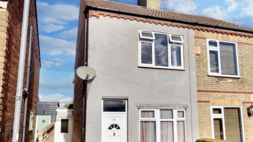 Unassuming three-bed home in Peterborough listed at £240,000 hides a striking Coca Cola themed lounge with bold red walls, memorabilia, and unique retro inspired decor.