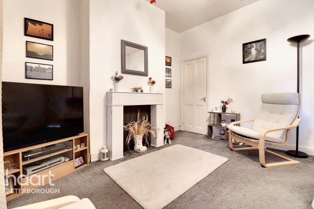 Unassuming three-bed home in Peterborough listed at £240,000 hides a striking Coca Cola themed lounge with bold red walls, memorabilia, and unique retro inspired decor.