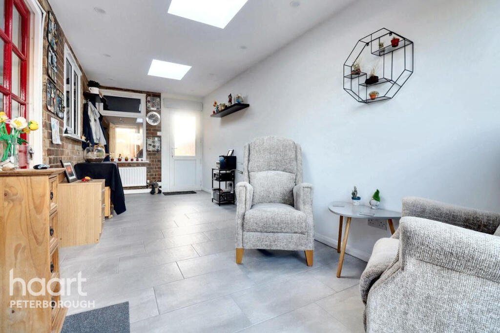 Unassuming three-bed home in Peterborough listed at £240,000 hides a striking Coca Cola themed lounge with bold red walls, memorabilia, and unique retro inspired decor.