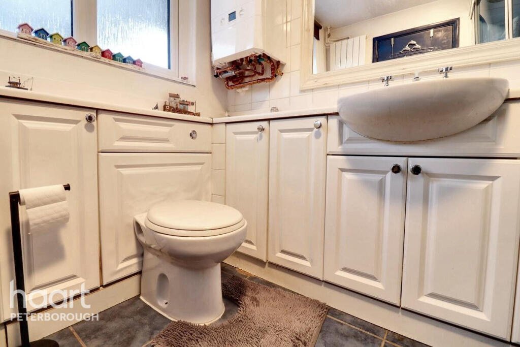 Unassuming three-bed home in Peterborough listed at £240,000 hides a striking Coca Cola themed lounge with bold red walls, memorabilia, and unique retro inspired decor.