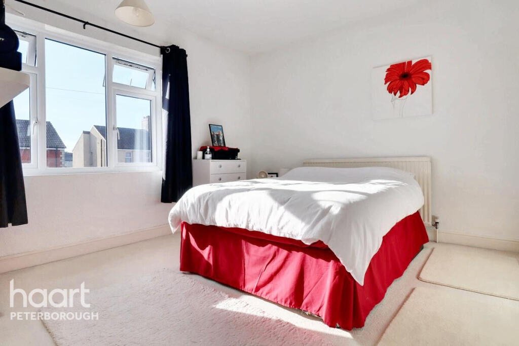 Unassuming three-bed home in Peterborough listed at £240,000 hides a striking Coca Cola themed lounge with bold red walls, memorabilia, and unique retro inspired decor.