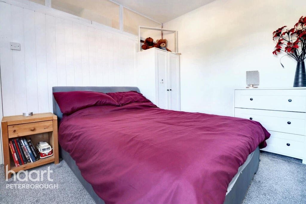 Unassuming three-bed home in Peterborough listed at £240,000 hides a striking Coca Cola themed lounge with bold red walls, memorabilia, and unique retro inspired decor.
