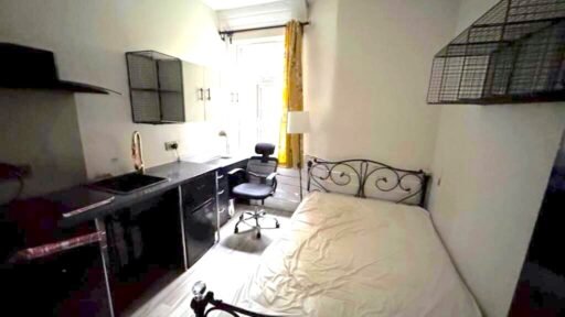 A Manchester student house with six bedrooms is on auction for £200,000, featuring private kitchens in each room near the University of Manchester and the famous Curry Mile.