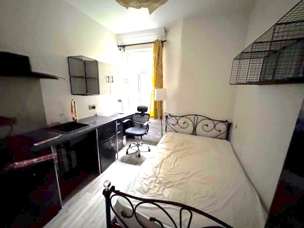 A Manchester student house with six bedrooms is on auction for £200,000, featuring private kitchens in each room near the University of Manchester and the famous Curry Mile.