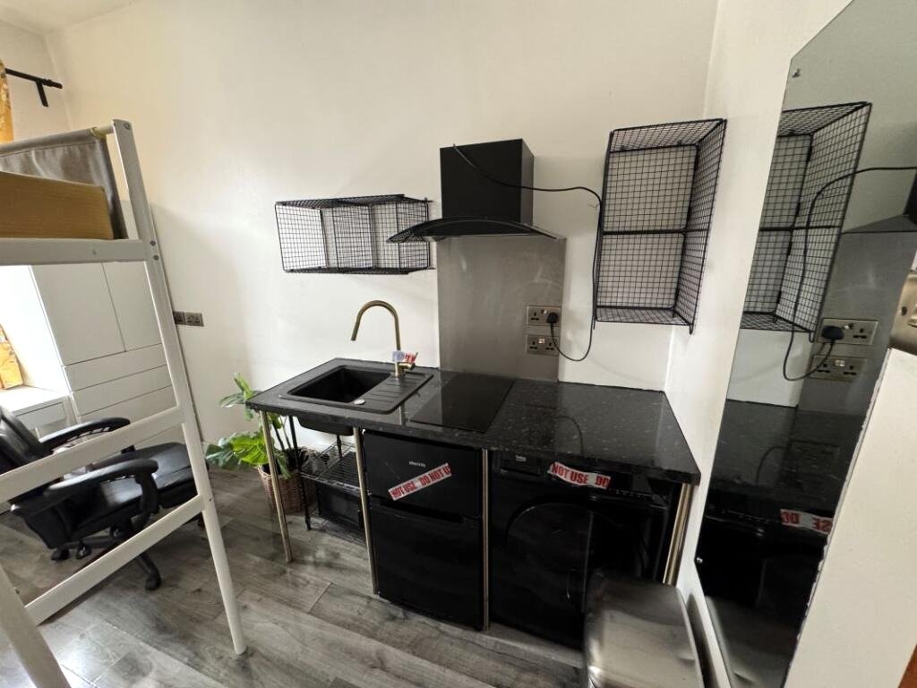 A Manchester student house with six bedrooms is on auction for £200,000, featuring private kitchens in each room near the University of Manchester and the famous Curry Mile.