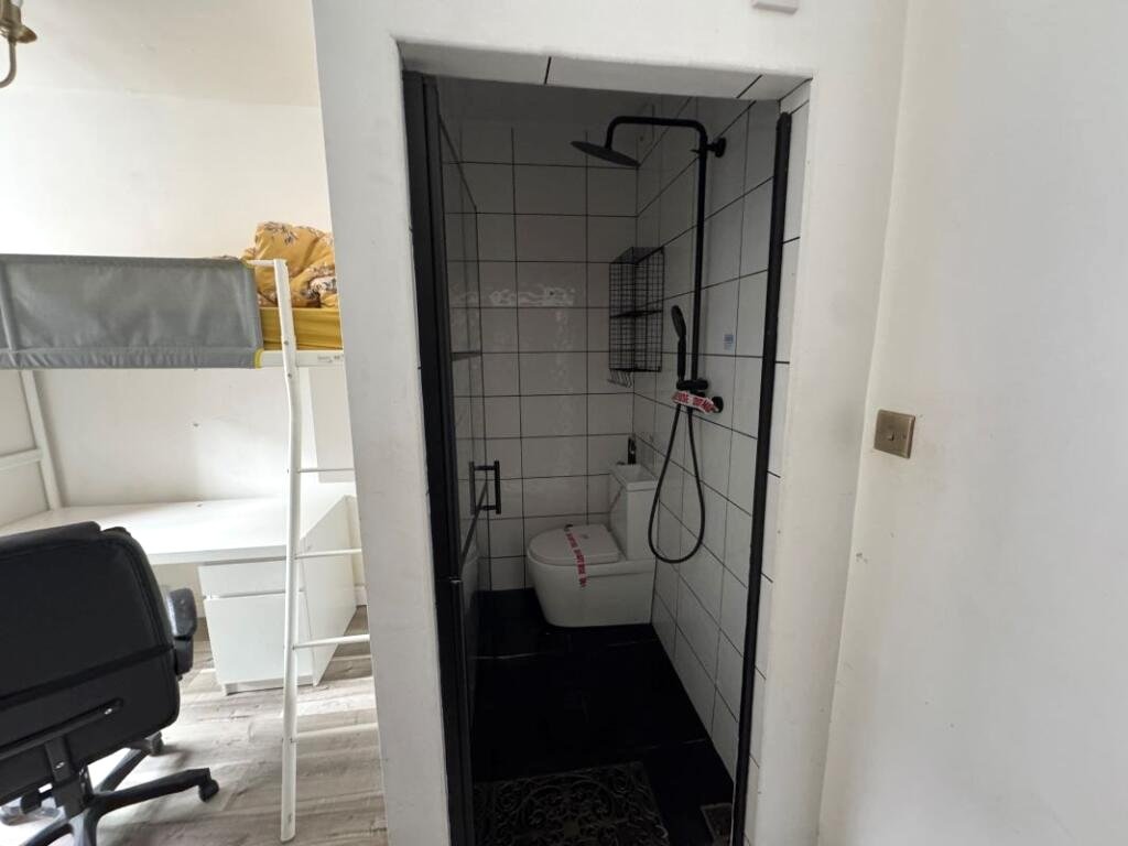 A Manchester student house with six bedrooms is on auction for £200,000, featuring private kitchens in each room near the University of Manchester and the famous Curry Mile.