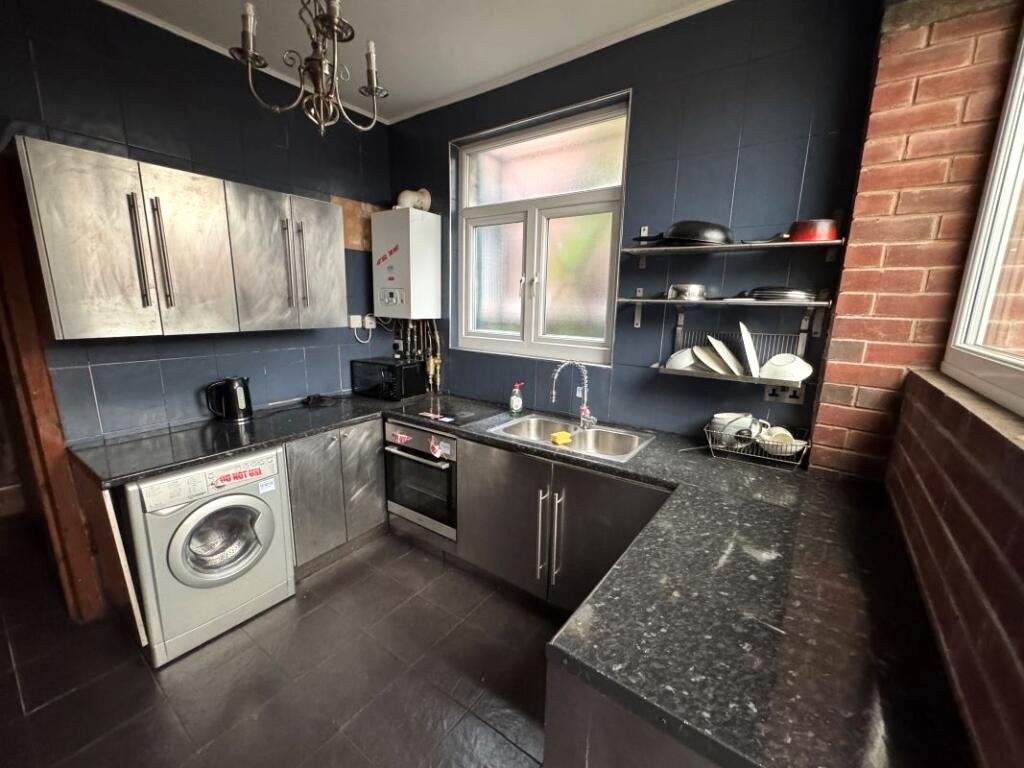 A Manchester student house with six bedrooms is on auction for £200,000, featuring private kitchens in each room near the University of Manchester and the famous Curry Mile.