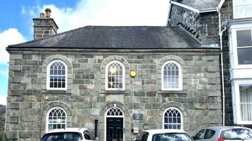 A former police station in Dolgellau with four original cells and three courtyards is on the market for £95,000, offering quirky charm and conversion potential.