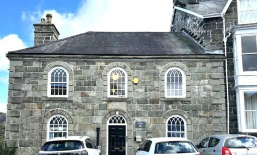 A former police station in Dolgellau with four original cells and three courtyards is on the market for £95,000, offering quirky charm and conversion potential.