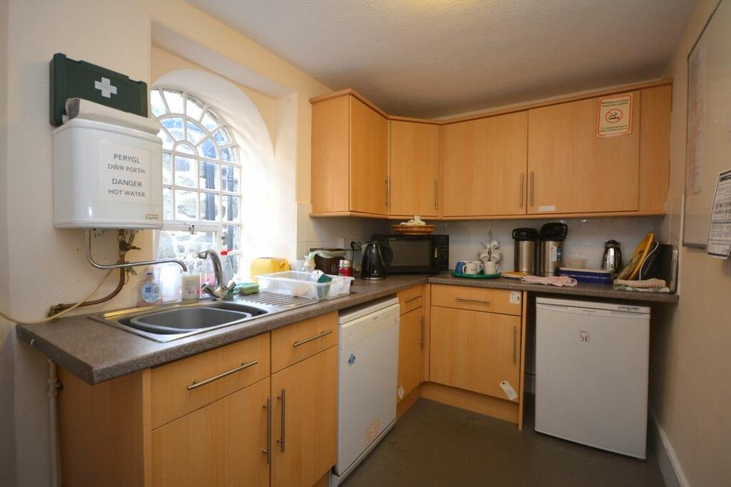 A former police station in Dolgellau with four original cells and three courtyards is on the market for £95,000, offering quirky charm and conversion potential.