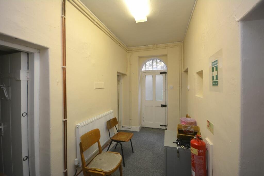 A former police station in Dolgellau with four original cells and three courtyards is on the market for £95,000, offering quirky charm and conversion potential.