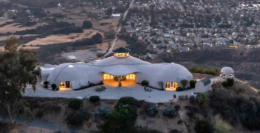 A $3 million California mountain home resembling The Flintstones’ Bedrock is up for sale, featuring domed architecture, a rock-carved pool, and breathtaking panoramic views.