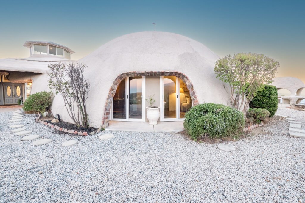 A $3 million California mountain home resembling The Flintstones’ Bedrock is up for sale, featuring domed architecture, a rock-carved pool, and breathtaking panoramic views.