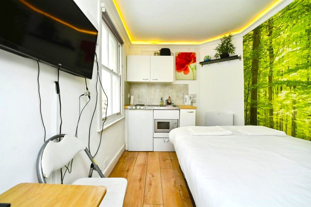 A Brighton studio flat so small you can cook from bed is on sale for £110,000, offering a compact seafront retreat with a kitchen, shower room and shared freehold.