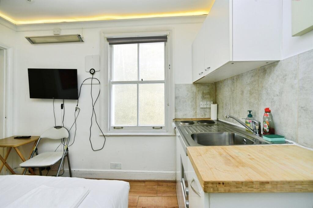 A Brighton studio flat so small you can cook from bed is on sale for £110,000, offering a compact seafront retreat with a kitchen, shower room and shared freehold.
