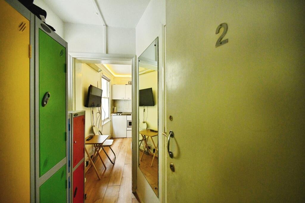 A Brighton studio flat so small you can cook from bed is on sale for £110,000, offering a compact seafront retreat with a kitchen, shower room and shared freehold.
