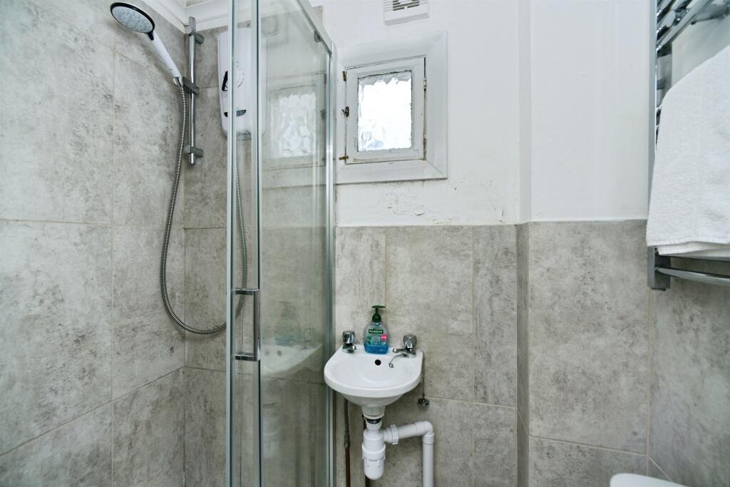 A Brighton studio flat so small you can cook from bed is on sale for £110,000, offering a compact seafront retreat with a kitchen, shower room and shared freehold.