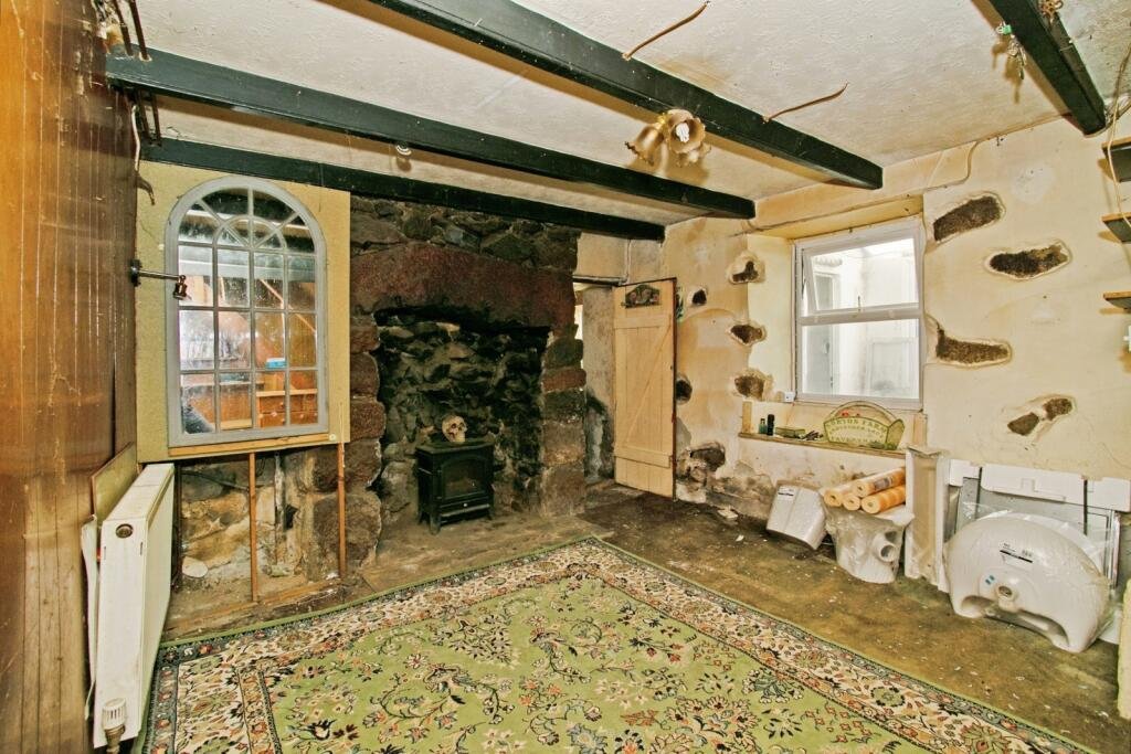 A two-bedroom cottage in Cornwall priced at £90,000 is drawing attention after photos revealed a mysterious skull on the fireplace amid its abandoned, timeworn interior.