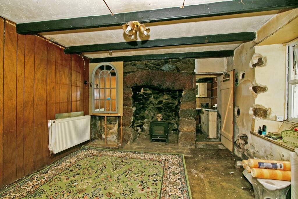 A two-bedroom cottage in Cornwall priced at £90,000 is drawing attention after photos revealed a mysterious skull on the fireplace amid its abandoned, timeworn interior.