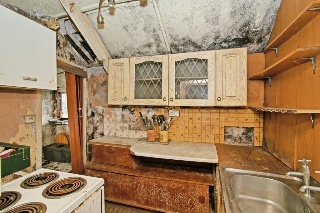 A two-bedroom cottage in Cornwall priced at £90,000 is drawing attention after photos revealed a mysterious skull on the fireplace amid its abandoned, timeworn interior.