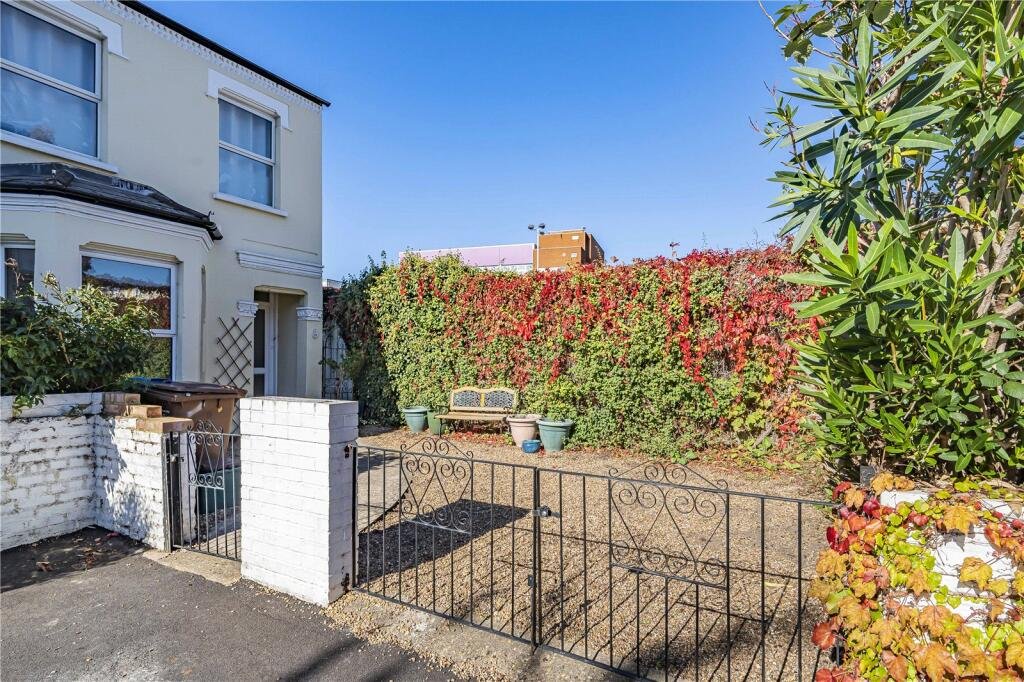 A parking space next to wheelie bins in Wimbledon is on sale for £22,500. The gated gravel spot near Wimbledon station is described as secure and priced for a quick sale.