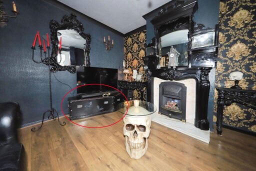 A £300,000 Bilston home has gone viral for its gothic décor featuring black walls, skulls, and a coffin used as a TV stand, offering a spooky twist on suburban living.