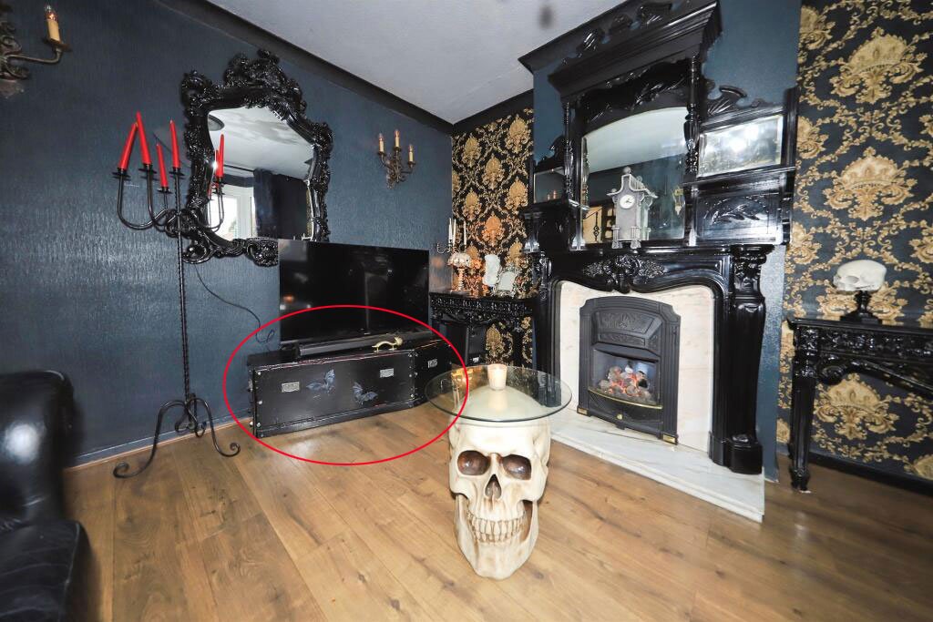 A £300,000 Bilston home has gone viral for its gothic décor featuring black walls, skulls, and a coffin used as a TV stand, offering a spooky twist on suburban living.