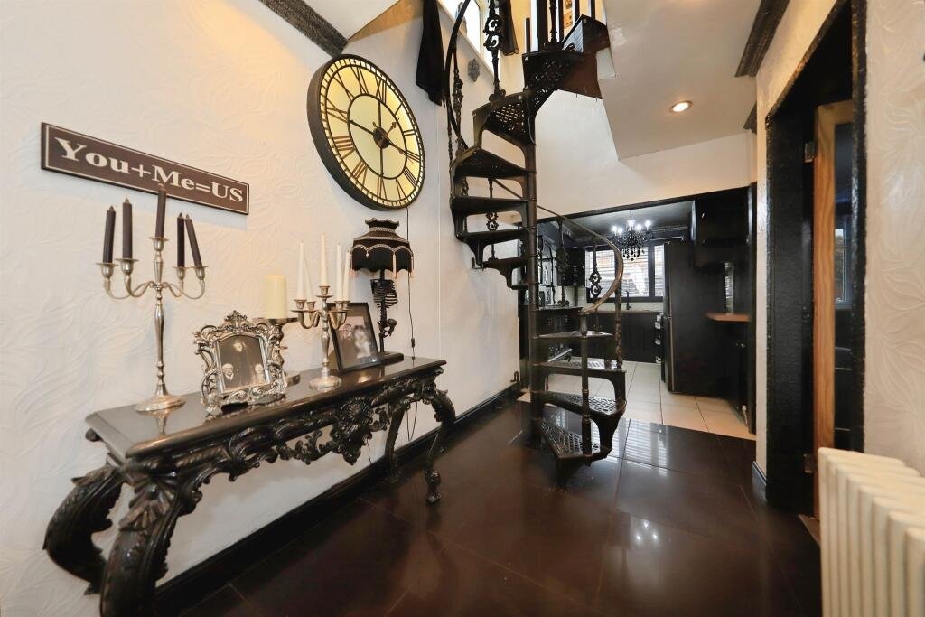 A £300,000 Bilston home has gone viral for its gothic décor featuring black walls, skulls, and a coffin used as a TV stand, offering a spooky twist on suburban living.