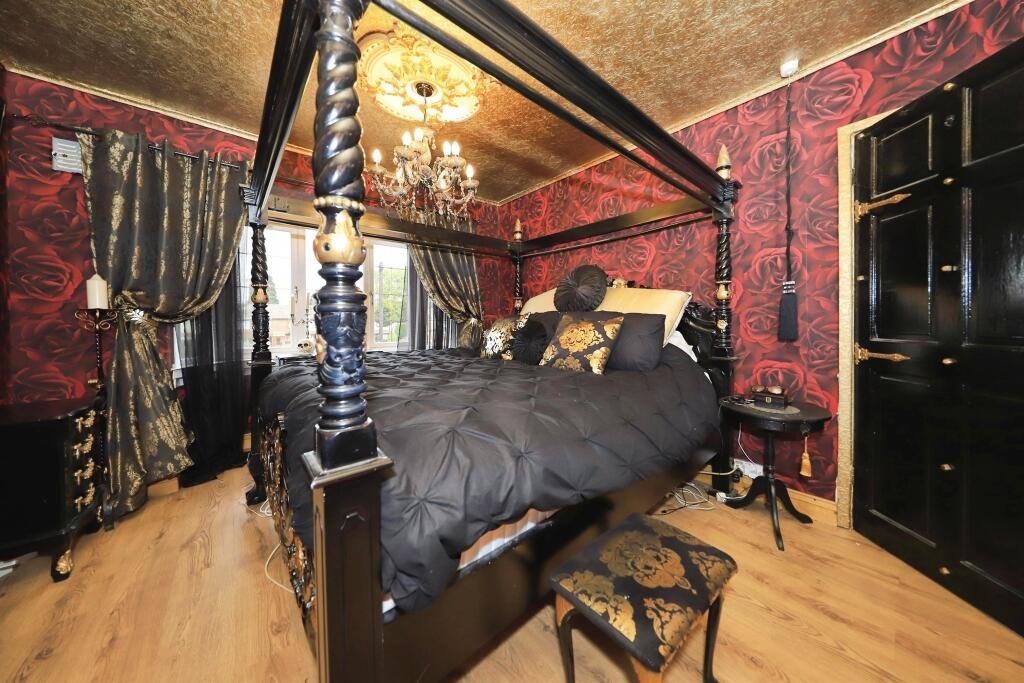 A £300,000 Bilston home has gone viral for its gothic décor featuring black walls, skulls, and a coffin used as a TV stand, offering a spooky twist on suburban living.