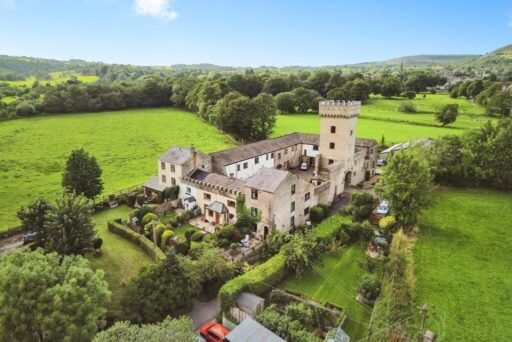 A 200 year old Rose Cottage within castle grounds in Bury is for sale at 250000 pounds offering two bedrooms cosy charm gardens parking and a unique semi rural setting today.
