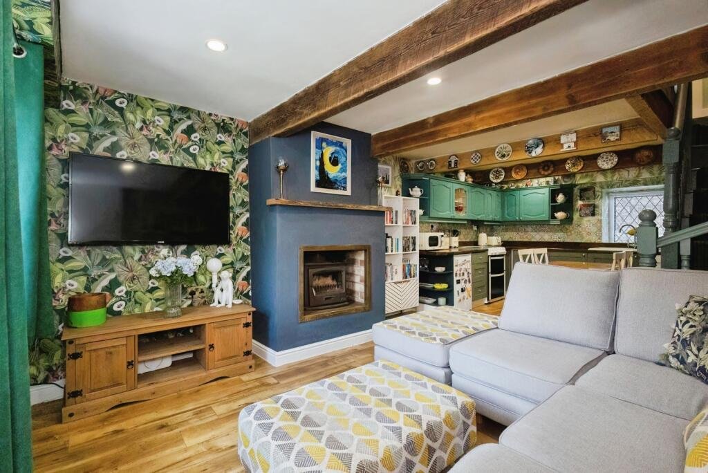 A 200 year old Rose Cottage within castle grounds in Bury is for sale at 250000 pounds offering two bedrooms cosy charm gardens parking and a unique semi rural setting today.