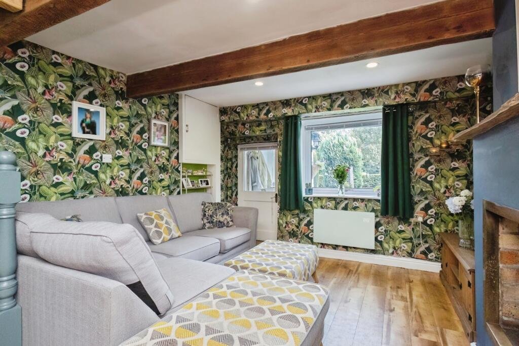 A 200 year old Rose Cottage within castle grounds in Bury is for sale at 250000 pounds offering two bedrooms cosy charm gardens parking and a unique semi rural setting today.