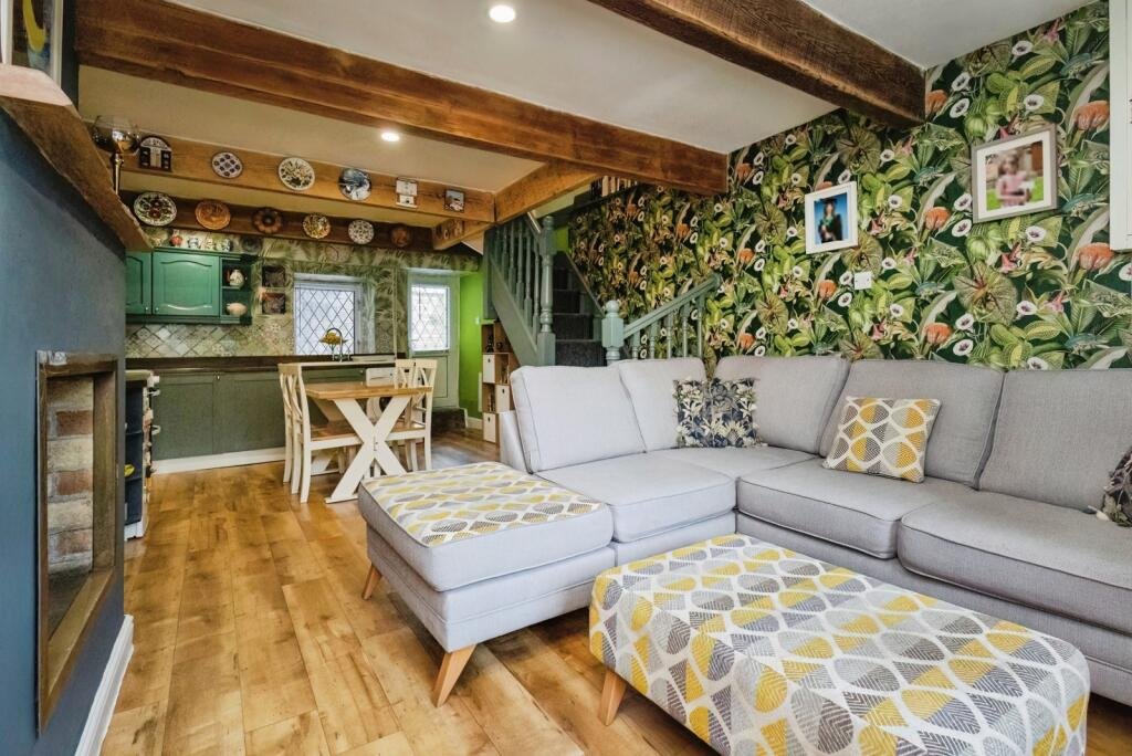 A 200 year old Rose Cottage within castle grounds in Bury is for sale at 250000 pounds offering two bedrooms cosy charm gardens parking and a unique semi rural setting today.