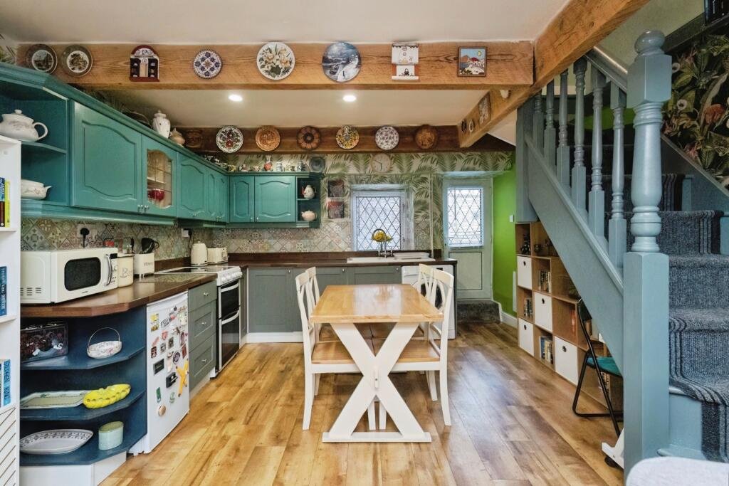 A 200 year old Rose Cottage within castle grounds in Bury is for sale at 250000 pounds offering two bedrooms cosy charm gardens parking and a unique semi rural setting today.