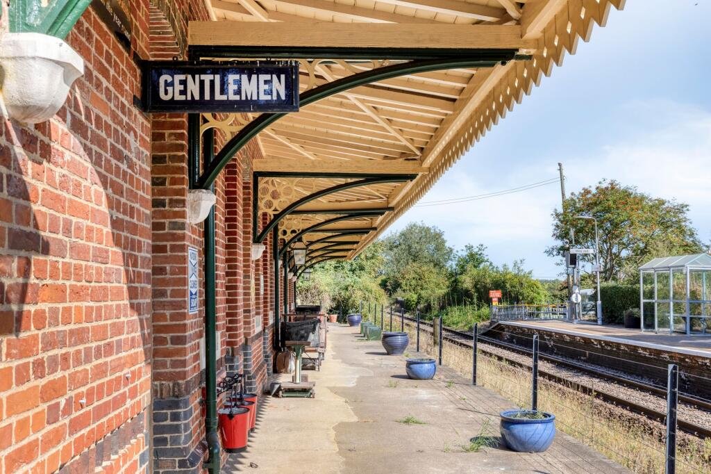 A former railway station once used by King Edward VII is for sale at £750000 offering three ensuite bedrooms original platform royal history and over an acre of landscaped grounds.