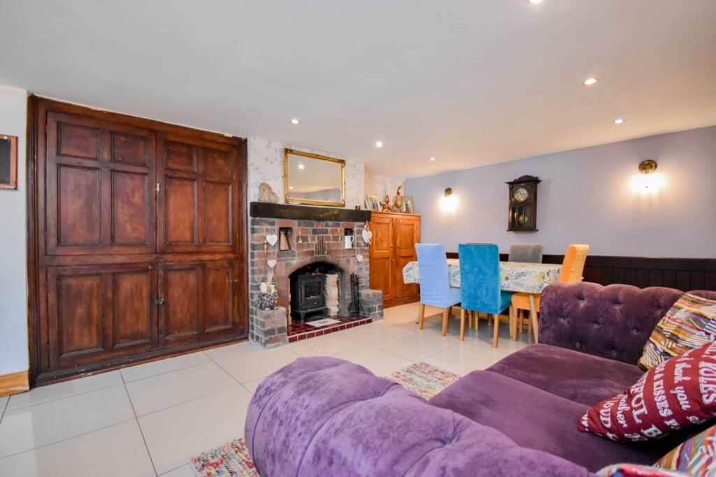 A quirky 1824 cottage in Penkhull priced at 410000 pounds features exposed beams modern spaces and a restored glass covered water well offering rare historic charm today.