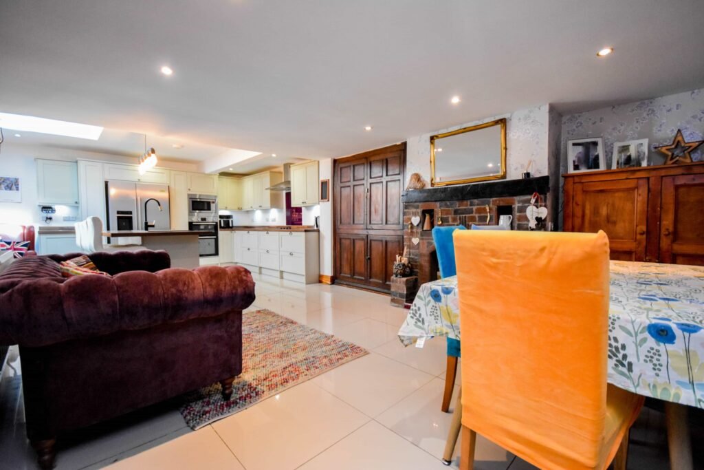 A quirky 1824 cottage in Penkhull priced at 410000 pounds features exposed beams modern spaces and a restored glass covered water well offering rare historic charm today.