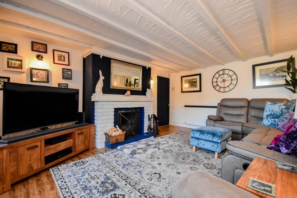 A quirky 1824 cottage in Penkhull priced at 410000 pounds features exposed beams modern spaces and a restored glass covered water well offering rare historic charm today.