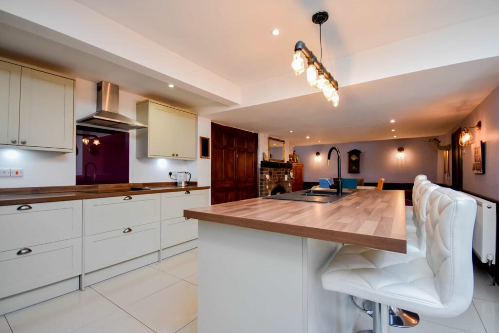 A quirky 1824 cottage in Penkhull priced at 410000 pounds features exposed beams modern spaces and a restored glass covered water well offering rare historic charm today.